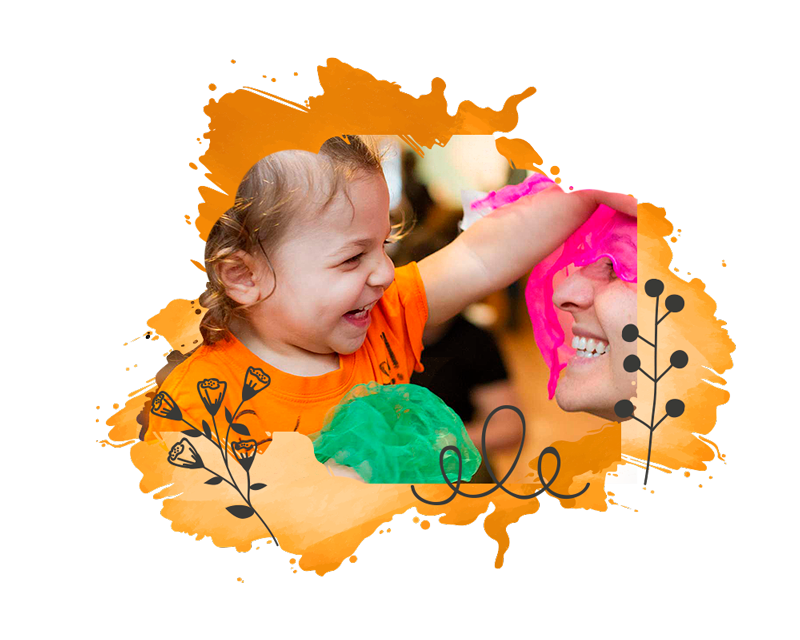 girl toddler smiling and happy with her mother at a mommy and me class at kids at work